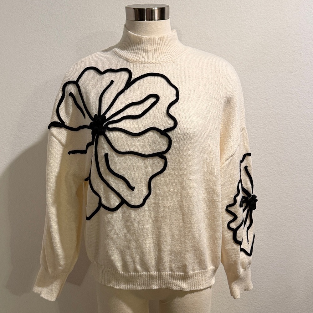 Elegant Cream Sweater with Black Floral Design